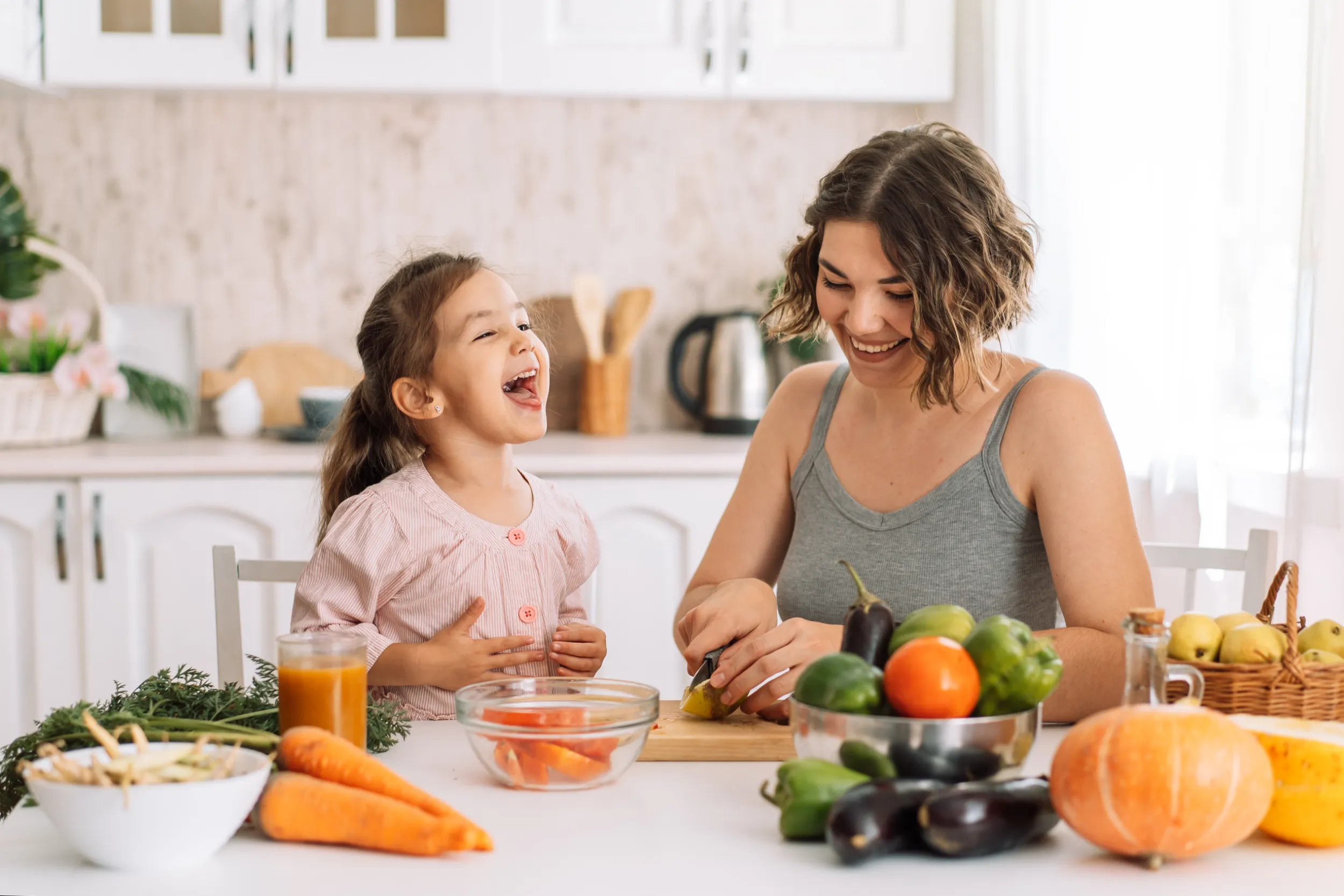 mom-and-daughter-smile-and-cook-together-2022-09-29-21-04-39-utc