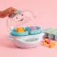 NB_Baby_Steamer_Defrost_Hand_Lifestyle-onPink_2100x2100