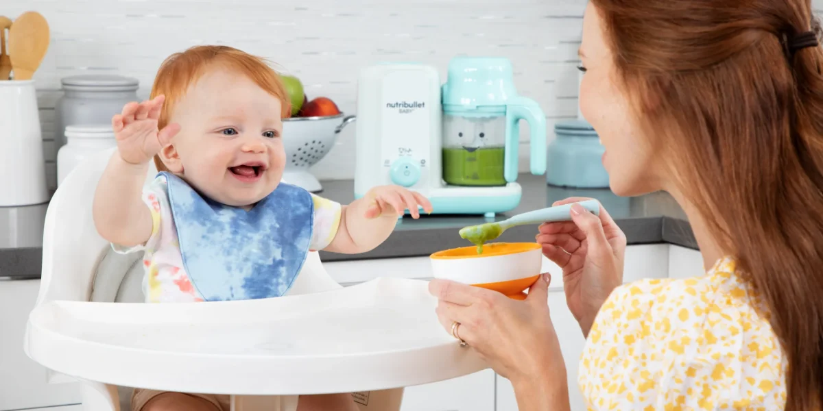 NB_Baby_Steam-Blend_Lifestyle_Mom-Baby_Eating-Puree_HiRes-scaled
