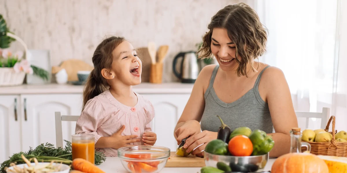 mom-and-daughter-smile-and-cook-together-2022-09-29-21-04-39-utc